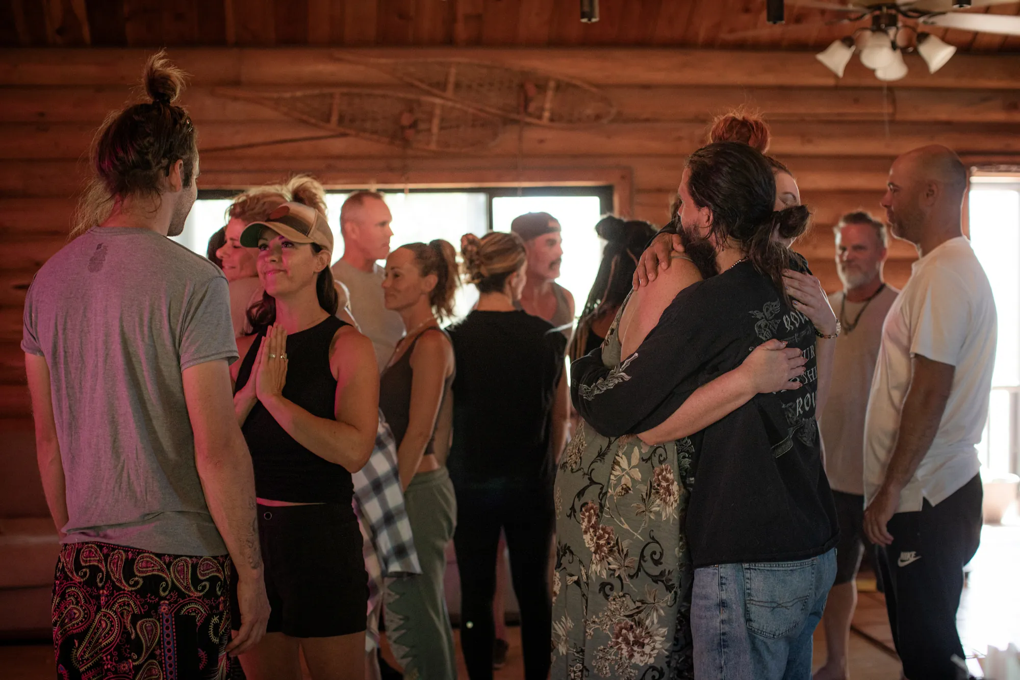 Apprentices gathered together in a wooden retreat cabin