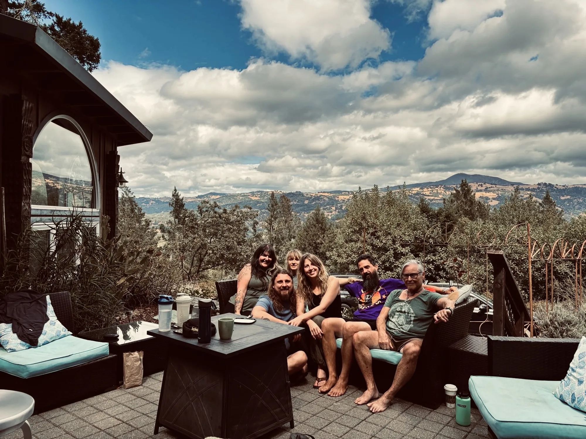 Apprentices relaxing together on a deck with mountains beyond